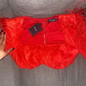 Beautiful red fashion crop top with feathers covering the shoulders f